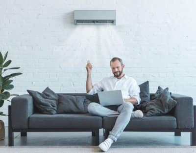 Man enjoying cool air with techno gas air conditioner services